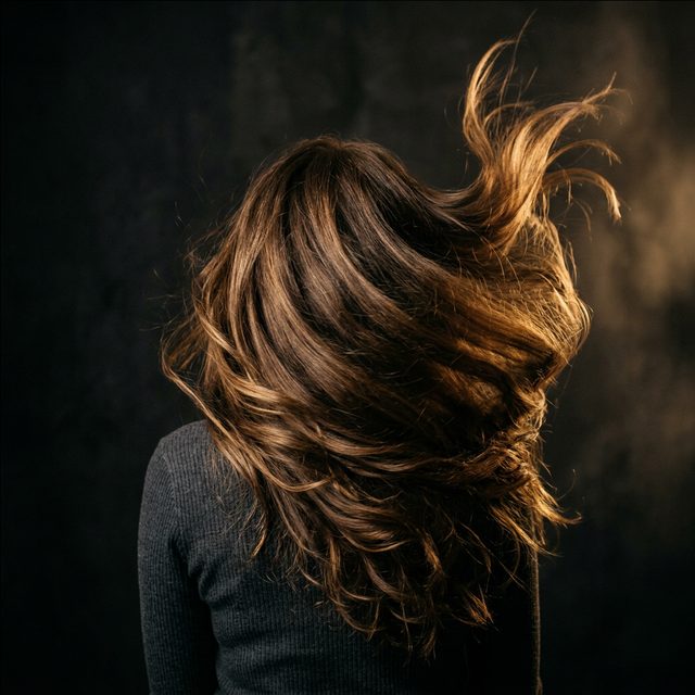 Voluminous hair in motion under warm light