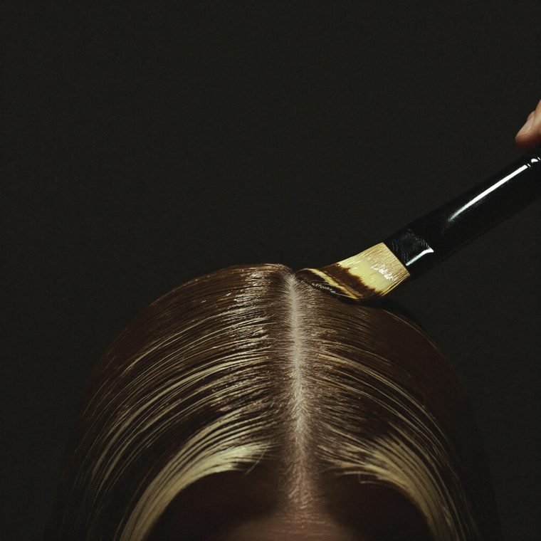 Color brush applying glossy color at the roots